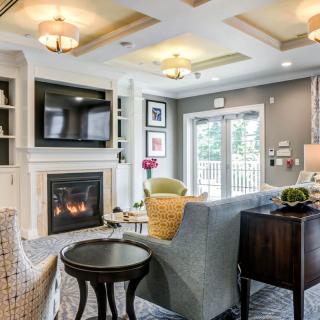 A beautifully designed living room with a cozy fireplace, elegant sofa, and modern decor.