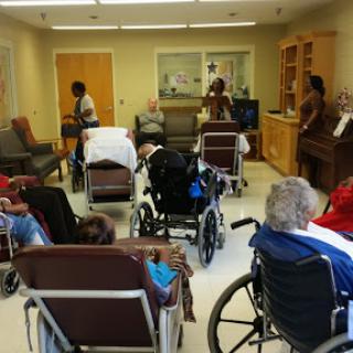 Residents engaged in a communal activity at a nursing home.