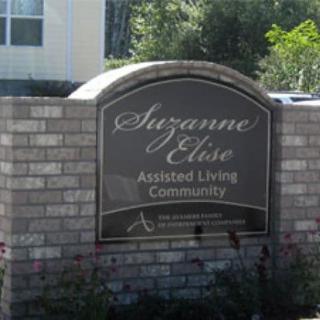 Sign for Suzanne Elise Assisted Living Community in front of a building.