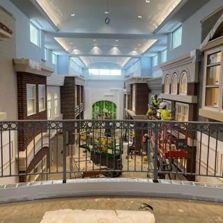 A spacious indoor atrium with architectural details and ample natural lighting.