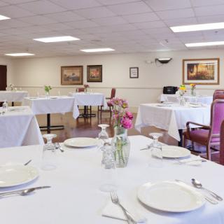 A beautifully arranged dining room with elegant tables set for guests.