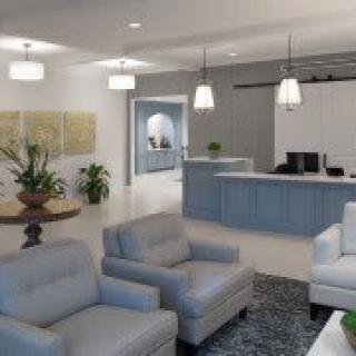 Modern office reception area with comfortable seating and a front desk.
