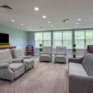 A spacious living room with comfortable seating and large windows.