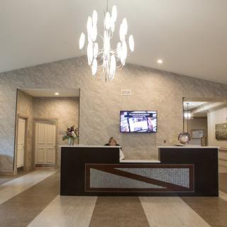 A modern reception area with a stylish chandelier and sleek design.