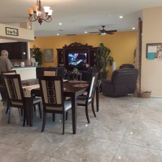 A spacious living and dining area with a dining table, television, and comfortable seating.