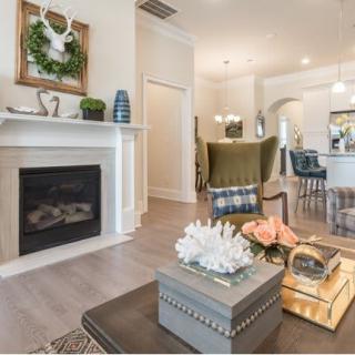 A modern living room with a cozy fireplace and stylish decor.