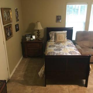 A cozy bedroom with a single bed and nightstand.