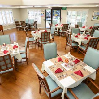 A well-organized dining room with neatly set tables and chairs.