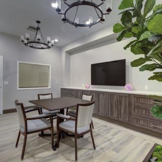 A contemporary dining area with a table, chairs, and modern decor.