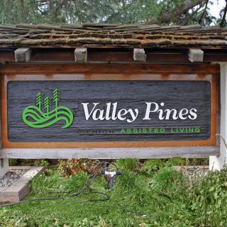 Entrance sign for Valley Pines set in a natural landscape.