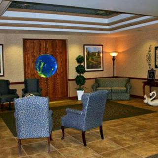 A cozy lobby area with comfortable seating and decorative plants.