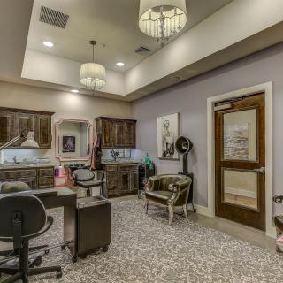 A well-designed office interior featuring elegant furniture, decorative elements, and ample lighting.