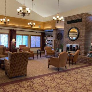 A cozy lobby area with comfortable seating and a fireplace.