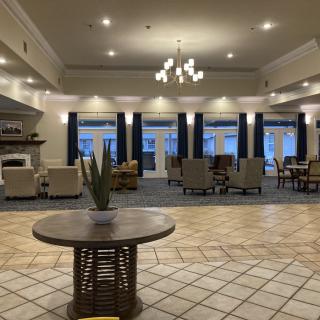 Spacious hotel lobby with seating areas and modern decor.