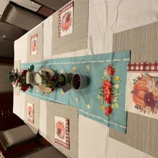 A beautifully set dining table ready for a Thanksgiving celebration.