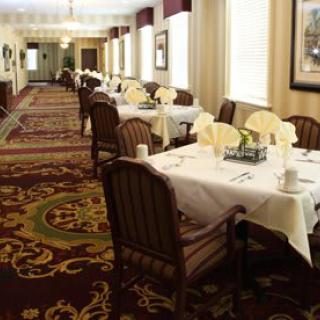 An elegantly decorated dining room with neatly arranged tables and chairs.