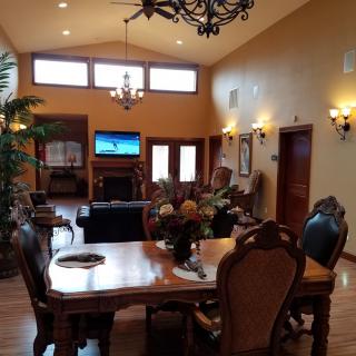 Spacious living and dining area with elegant furnishings and high ceilings.