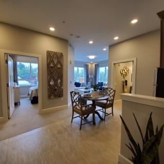 A modern living and dining area with stylish furniture and warm lighting.