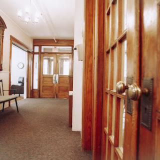 A warm and inviting corridor featuring wooden doors and stylish decor.