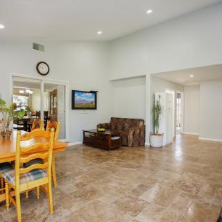 Spacious living and dining area with tiled flooring and cozy seating.