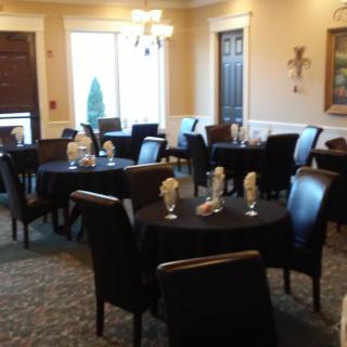 An elegant dining room with neatly arranged tables and chairs, ready for guests.