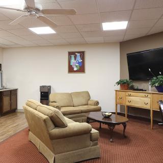 A cozy living room with sofas, a coffee table, and a television.