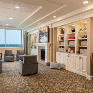 A cozy living room with comfortable seating, a fireplace, and built-in shelves.