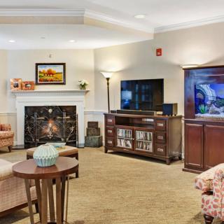 A cozy living room with a fireplace, television, and comfortable seating.