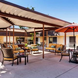 A spacious outdoor patio with comfortable seating and umbrellas, perfect for relaxation.