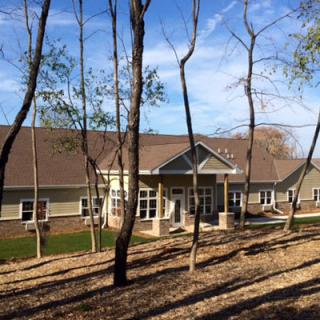 A house surrounded by trees on a clear day.