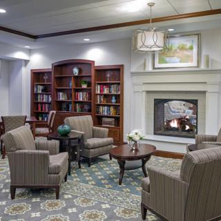 A cozy library with a fireplace and comfortable seating area.