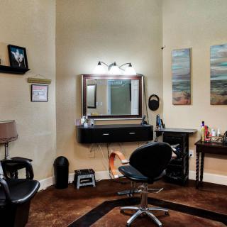 Cozy hair salon interior with styling stations and modern decor.