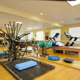 A well-equipped gym with a variety of exercise machines and fitness tools.