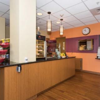 Interior of a cozy coffee shop with a snack and beverage counter.