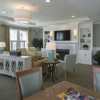 A cozy living room with elegant furnishings and a fireplace.
