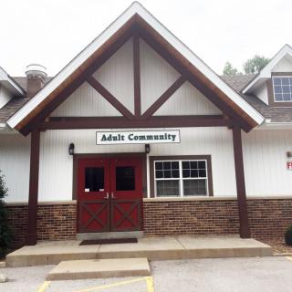 The entrance to a community center with a sign above the door.