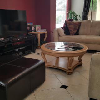 A cozy living room featuring a stylish coffee table, comfortable sofa, and a television setup.