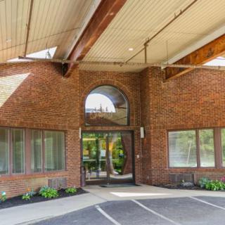 An entrance to a brick building with a covered driveway.