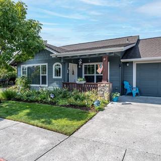 A suburban house with a well-maintained front yard and a driveway.