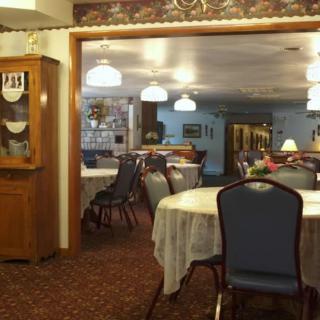 An indoor dining area in a restaurant with tables and chairs arranged neatly.