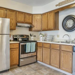 A modern kitchen with wooden cabinets and stainless steel appliances.