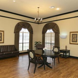 A well-lit office waiting area with elegant furnishings and large windows.