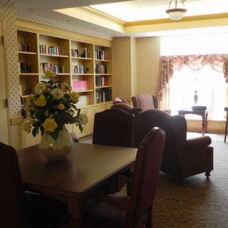 A cozy reading room with bookshelves and comfortable seating.