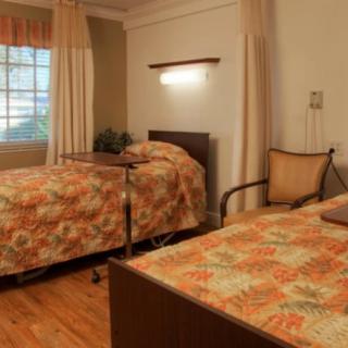 A cozy bedroom with twin beds and floral bedding.