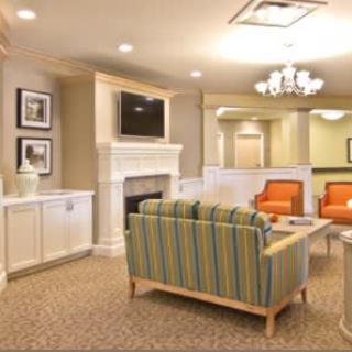 A cozy living room with a fireplace, television, and comfortable seating.