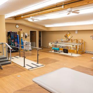 A spacious and well-equipped physical therapy room designed for rehabilitation exercises.