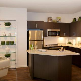 A modern kitchen with stainless steel appliances and a central island.