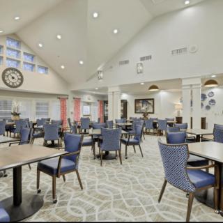 A spacious and modern dining area with neatly arranged tables and chairs.