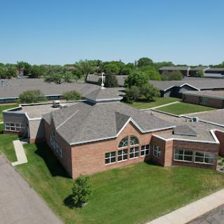 Aerial view of a school campus surrounded by greenery.