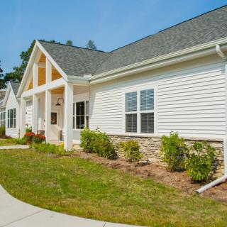 A modern suburban house with a neatly landscaped front yard.